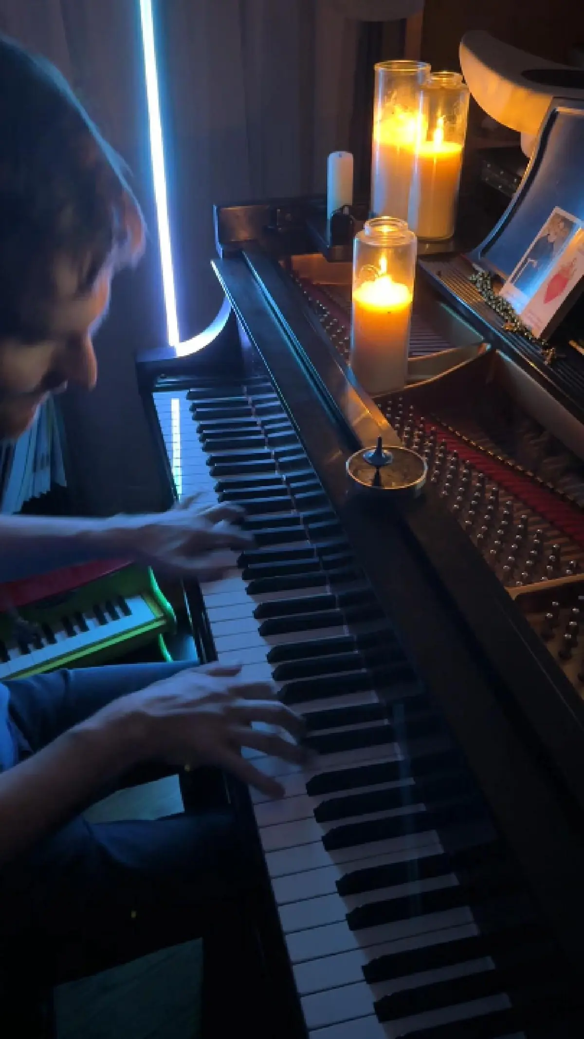 Sean playing piano by candlelight